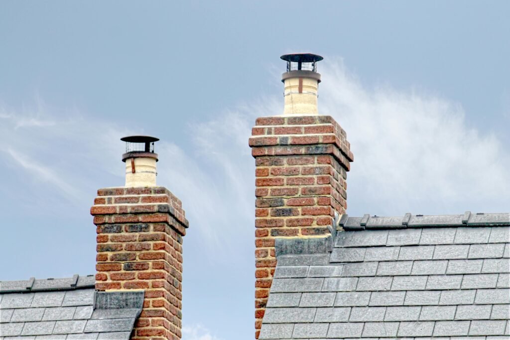 pexels photo 11210095 11210095 Close-up of traditional brick chimneys on a slate roof, England.