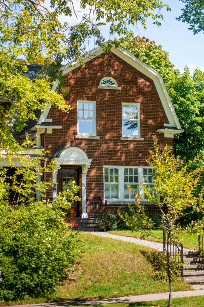 pexels photo 14507203 14507203 Charming brick house with lush greenery in suburban Québec, Canada.